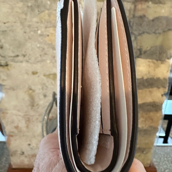 Kate Spade wallet is a light pink wallet adorned with small heart-shaped studs - Picture 8 of 16